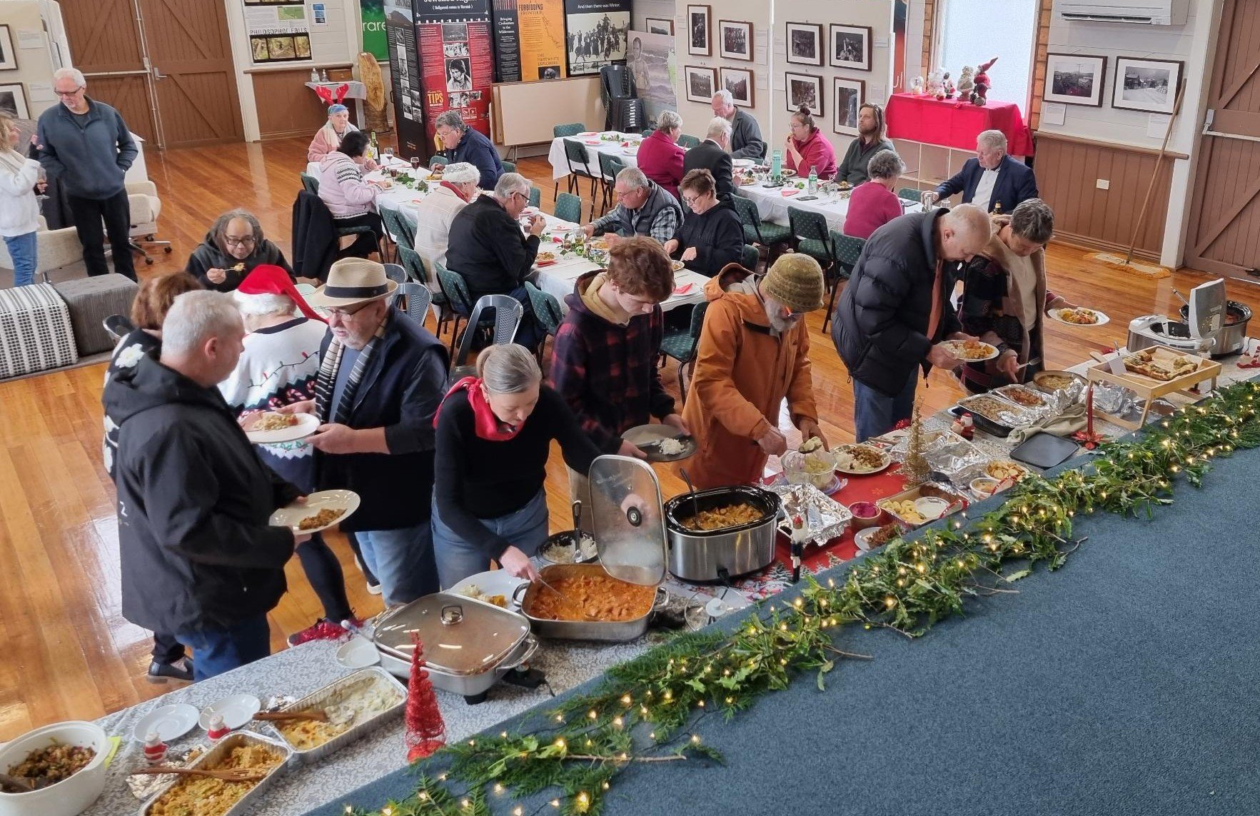 Community members sharing food at Christmas in July
